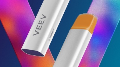 VEEV NOW peach device on a promotional banner